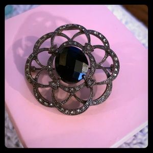 Woman’s black brooch